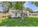 Exterior shot of a single-story home with a well-manicured lawn and fenced yard on a sunny day at 402 Woodward Blvd, Summerville, SC 29483