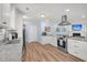 Bright kitchen with stainless appliances, white cabinets, and an open design leading into the living area at 402 Woodward Blvd, Summerville, SC 29483