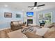Comfortable living room with a fireplace, sofas, and a large window providing ample natural light at 402 Woodward Blvd, Summerville, SC 29483