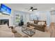 Comfortable living room with wood-look floors, fireplace, ceiling fan, and large window with natural light at 402 Woodward Blvd, Summerville, SC 29483