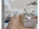 Open-concept living space with hardwood floors, a modern kitchen, and a dining area at 402 Woodward Blvd, Summerville, SC 29483