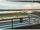 Poolside view of waterfront dock featuring upper level structure and American flag at 4352 Bream Rd Rd, North Charleston, SC 29418