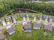 Aerial view of a neighborhood with a tranquil pond and lush greenery at 443 Coopers Hawk Dr, Summerville, SC 29483