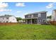 Large backyard with lush green grass, a covered patio, and a privacy fence; great for outdoor activities at 443 Coopers Hawk Dr, Summerville, SC 29483