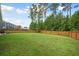 Expansive backyard with lush green grass and a privacy fence, great for outdoor activities at 443 Coopers Hawk Dr, Summerville, SC 29483