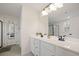 Elegant bathroom featuring a double vanity with white countertops, black fixtures, and modern lighting, creating a spa-like retreat at 443 Coopers Hawk Dr, Summerville, SC 29483