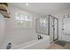 Modern bathroom with a soaking tub, glass-enclosed shower, and stylish fixtures, creating a luxurious and functional space at 443 Coopers Hawk Dr, Summerville, SC 29483