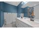 Stylish bathroom with a double sink vanity, wainscoting, and a blue accent wall at 443 Coopers Hawk Dr, Summerville, SC 29483