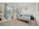 Serene bedroom with a brass bed frame, light-filled windows with patterned curtains, and neutral carpet flooring at 443 Coopers Hawk Dr, Summerville, SC 29483