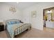 Bright bedroom with a brass bed frame, blue accents, and an en-suite bathroom for added convenience and comfort at 443 Coopers Hawk Dr, Summerville, SC 29483