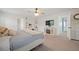 Bright bedroom with a cozy bed, a decorative fireplace, and a vanity area, providing comfort and style at 443 Coopers Hawk Dr, Summerville, SC 29483