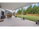Spacious covered patio with outdoor seating, perfect for entertaining in a fenced yard with mature trees at 443 Coopers Hawk Dr, Summerville, SC 29483