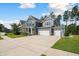 Charming two-story home with a three car garage, covered front porch, and basketball hoop at 443 Coopers Hawk Dr, Summerville, SC 29483