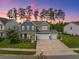 Charming two-story home with a three car garage, landscaped yard and inviting front porch at 443 Coopers Hawk Dr, Summerville, SC 29483