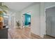 Inviting hallway featuring a plant, leading to an office with a blue accent wall and wainscoting at 443 Coopers Hawk Dr, Summerville, SC 29483