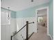 Inviting hallway showcasing wainscoting, a staircase, and view of a bedroom at 443 Coopers Hawk Dr, Summerville, SC 29483