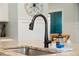 Close-up of a kitchen sink area with granite countertops and stylish faucet; a chef's dream at 443 Coopers Hawk Dr, Summerville, SC 29483