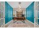 Stylish home office with custom paneling, a large desk, and eye-catching light fixture at 443 Coopers Hawk Dr, Summerville, SC 29483