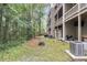 Backyard area showing the exterior with attached wooden decks, lush green trees, and wooded area at 4630 Palm View Cir, North Charleston, SC 29418