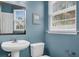 Powder room featuring tile flooring, a pedestal sink, and blue walls at 4630 Palm View Cir, North Charleston, SC 29418