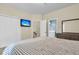 Nicely furnished bedroom with television, double closets, and an open doorway to the bathroom at 4630 Palm View Cir, North Charleston, SC 29418
