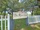 A charming community sign that reads 'The River Club' welcomes members and guests with mature trees at 4630 Palm View Cir, North Charleston, SC 29418