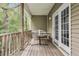 Covered wooden deck with a cloth hammock hanging, offering relaxing outdoor living at 4630 Palm View Cir, North Charleston, SC 29418