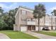 Charming townhome with a one car garage and a well manicured lawn, with a palm tree at 4630 Palm View Cir, North Charleston, SC 29418