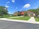 Modern brick building with red roof, green lawn, and ample parking space for a comfortable living experience at 4630 Palm View Cir, North Charleston, SC 29418
