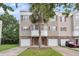 Charming townhome with a one car garage and a well manicured lawn, with a palm tree at 4630 Palm View Cir, North Charleston, SC 29418