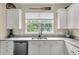 Modern kitchen features white cabinets, granite countertops, and stainless-steel appliances at 4630 Palm View Cir, North Charleston, SC 29418