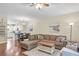 Spacious living room with hardwood floors, sectional sofa, and an open floor plan to the kitchen and dining area at 4630 Palm View Cir, North Charleston, SC 29418