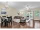 Open-concept living area features hardwood floors and ample sunlight from the french doors to the outside at 4630 Palm View Cir, North Charleston, SC 29418