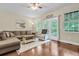 Cozy living room with hardwood floors, neutral colors, and lots of natural light at 4630 Palm View Cir, North Charleston, SC 29418