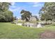Scenic view of a pond surrounded by lush greenery and buildings in the background at 4630 Palm View Cir, North Charleston, SC 29418