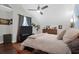 Bright bedroom with a ceiling fan, TV, and hardwood floors, creating a cozy and inviting space at 4752 Trailside Ct # B, North Charleston, SC 29418