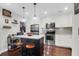 Well-lit kitchen with stainless steel appliances, an island with barstools, and white cabinetry at 4752 Trailside Ct # B, North Charleston, SC 29418