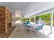 Covered outdoor patio seating area with a fireplace overlooking the community pool and pond at 4752 Trailside Ct # B, North Charleston, SC 29418