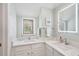 Stylish bathroom with dual sinks, stone countertops, and a well-lit vanity area at 4856 Green Dolphin Way # Share 5, Kiawah Island, SC 29455