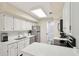Updated kitchen featuring white cabinets, stainless steel appliances, and stone countertops at 4856 Green Dolphin Way # Share 5, Kiawah Island, SC 29455