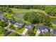 Aerial view of a residential neighborhood with homes backing onto a golf course and pond at 5256 Mulholland Dr, Summerville, SC 29485