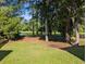 Scenic backyard featuring lush green lawn and tranquil water views framed by mature trees at 5256 Mulholland Dr, Summerville, SC 29485