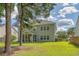 View of the rear of the home, featuring a screened porch and large yard at 5256 Mulholland Dr, Summerville, SC 29485
