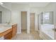 Bathroom with double vanity, tile floor, walk-in closet, walk-in shower and soaking tub at 5256 Mulholland Dr, Summerville, SC 29485