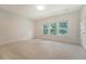 Well-lit bedroom features three windows and neutral carpet at 5256 Mulholland Dr, Summerville, SC 29485
