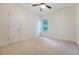 Bright bedroom with neutral carpet, ceiling fan, and a window at 5256 Mulholland Dr, Summerville, SC 29485