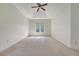 Bedroom featuring a tray ceiling, ceiling fan, carpeted floor, and natural light from a window at 5256 Mulholland Dr, Summerville, SC 29485
