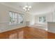 Bright dining room featuring hardwood floors, natural light from multiple windows, and classic chandelier at 5256 Mulholland Dr, Summerville, SC 29485