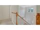 Bright entryway with hardwood floors, stairs with wooden railing and a transom window at 5256 Mulholland Dr, Summerville, SC 29485