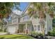 Attractive two-story home showcasing a well-kept lawn, an attached garage, and professional landscaping at 5256 Mulholland Dr, Summerville, SC 29485